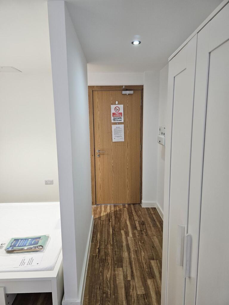 Bright and clean hallway with modern wooden flo...