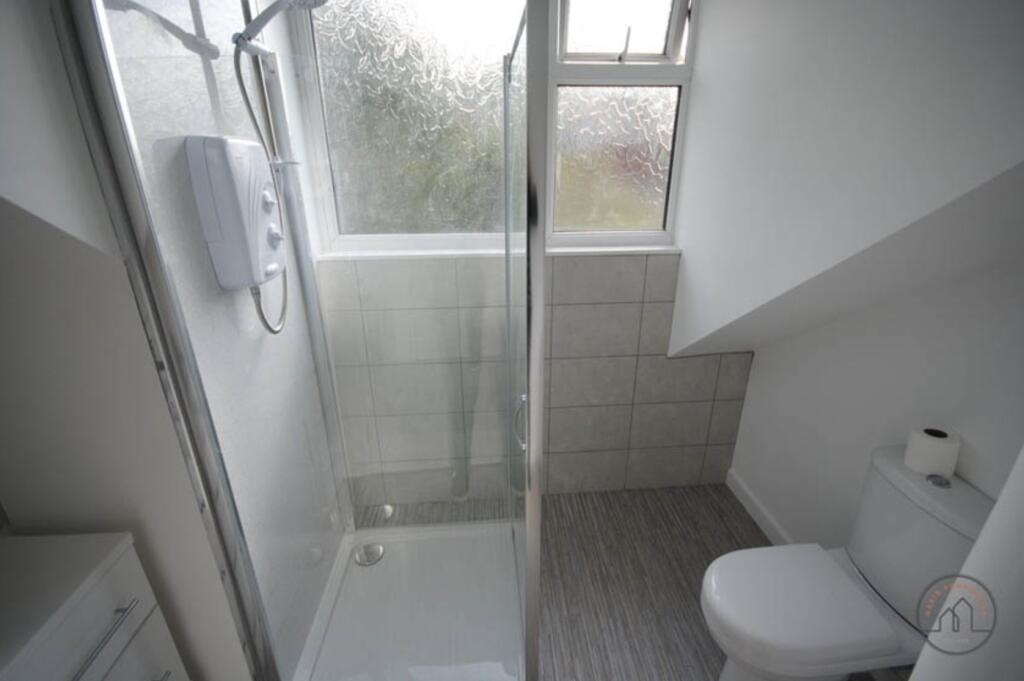 A clean, modern bathroom featuring a spacious s...