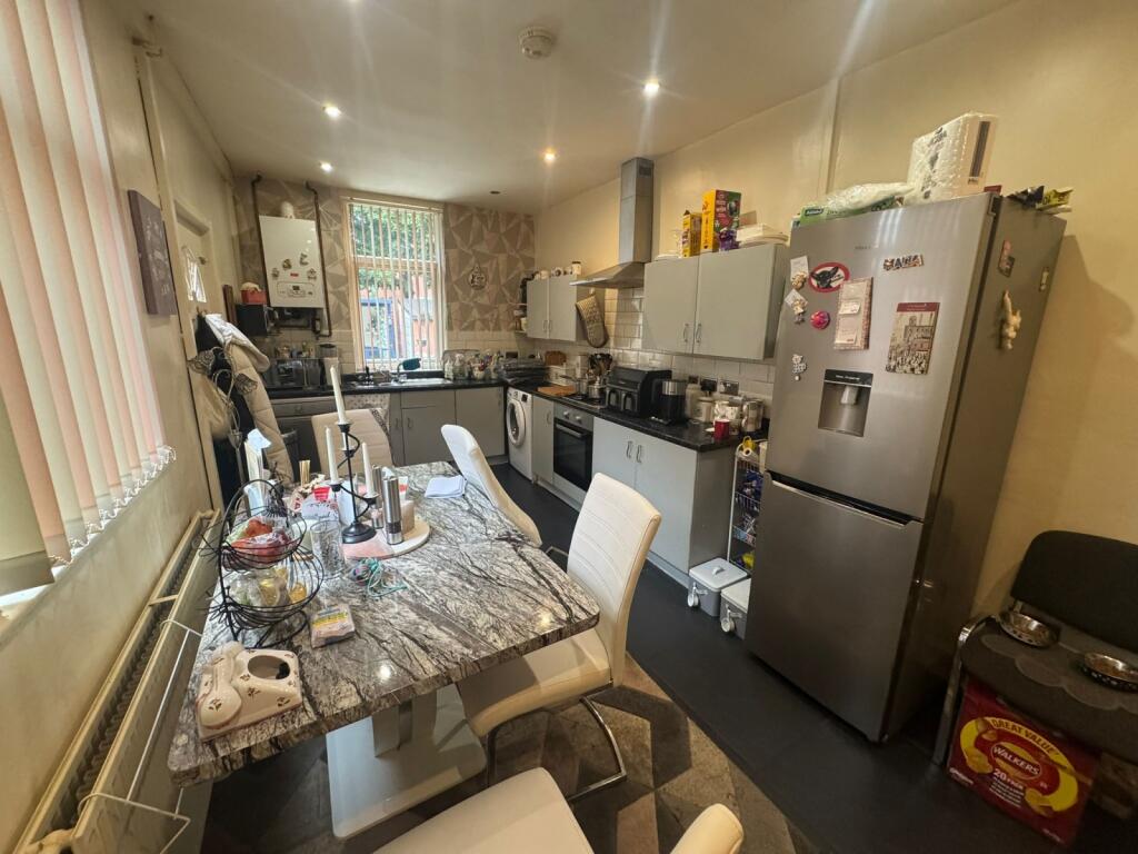 A functional kitchen featuring a dining table w...