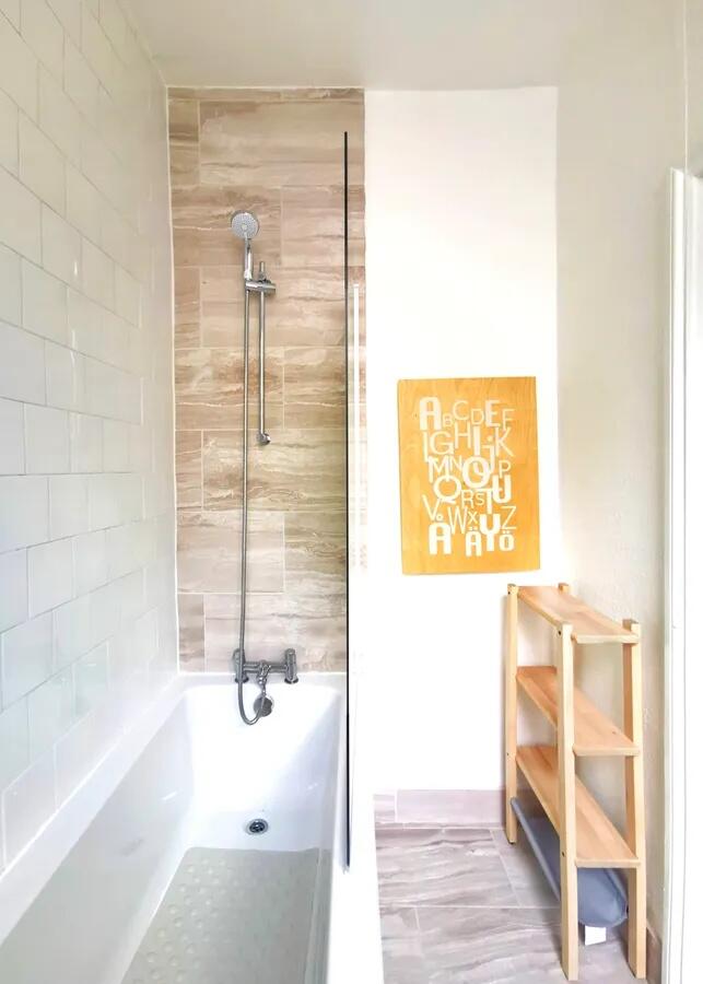 Bright and modern bathroom suite featuring a sl...