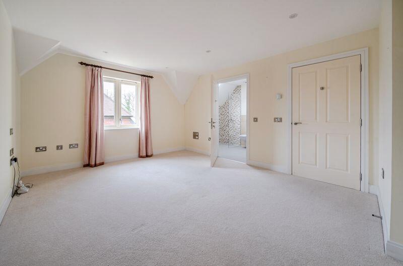 Bedroom with fitted wardrobes and ens...