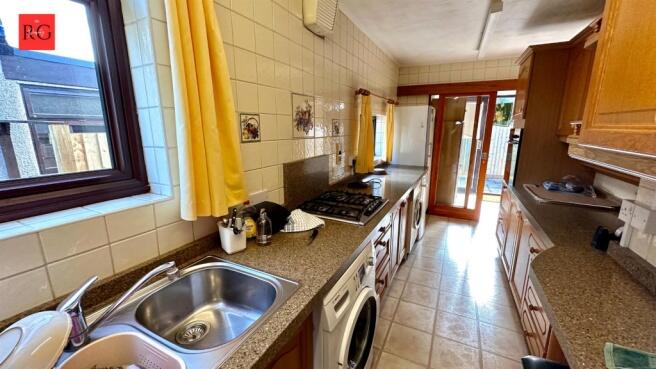 Bright and practical galley kitchen featuring a...