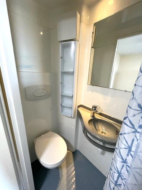 Compact and clean single toilet space featuring...