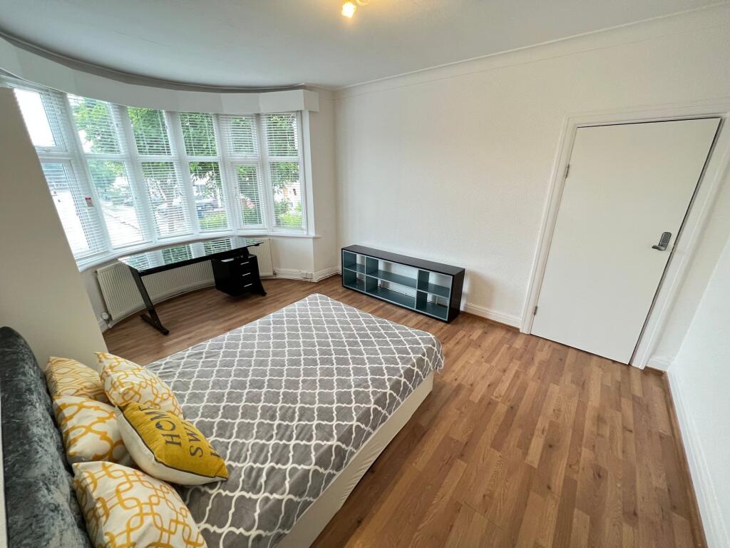 Bright and spacious master bedroom featuring a ...