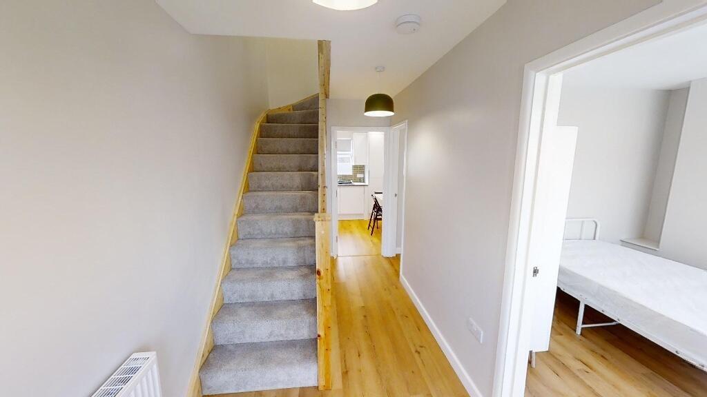Bright and tidy hallway featuring light wooden ...