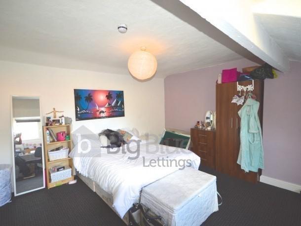 A spacious and neatly arranged master bedroom f...
