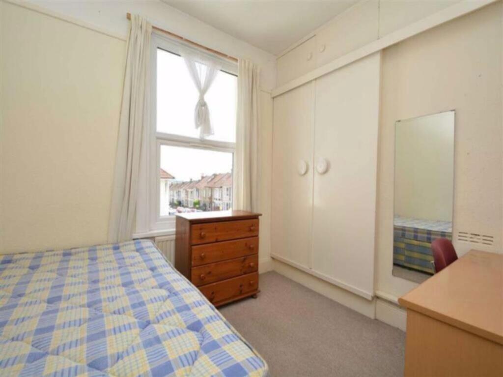 A bright and tidy double bedroom featuring ampl...