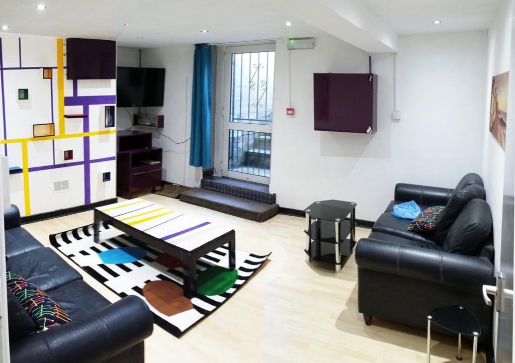 A stylish living room featuring modern black le...