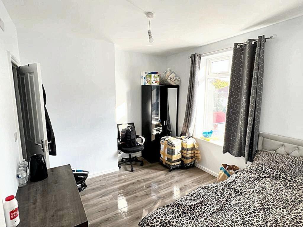 Spacious double bedroom featuring large windows...
