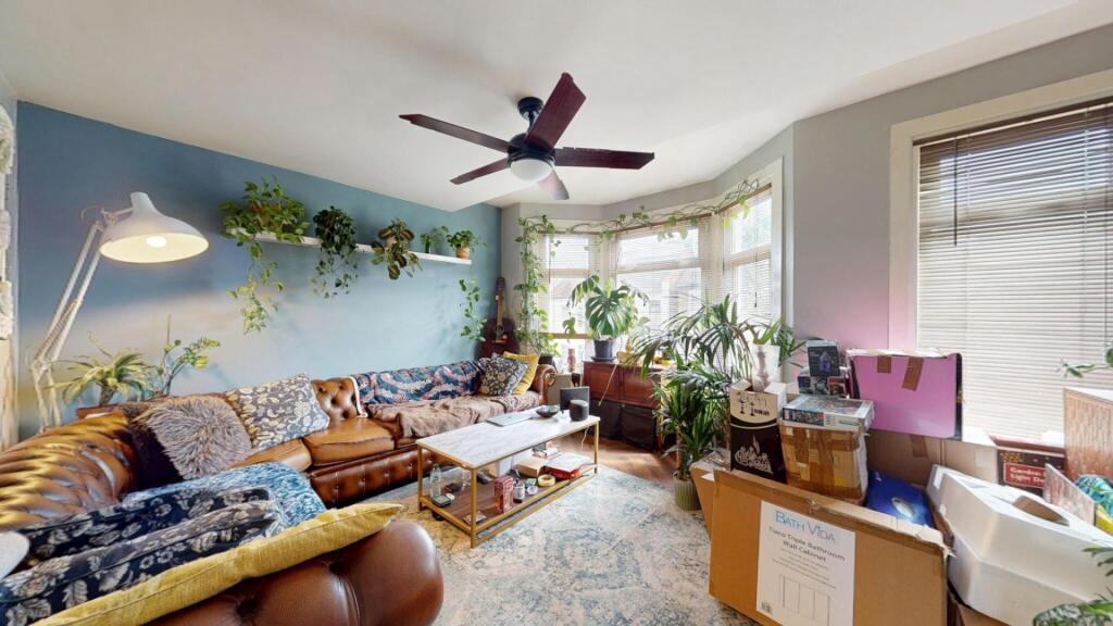 A bright and welcoming living room featuring a ...