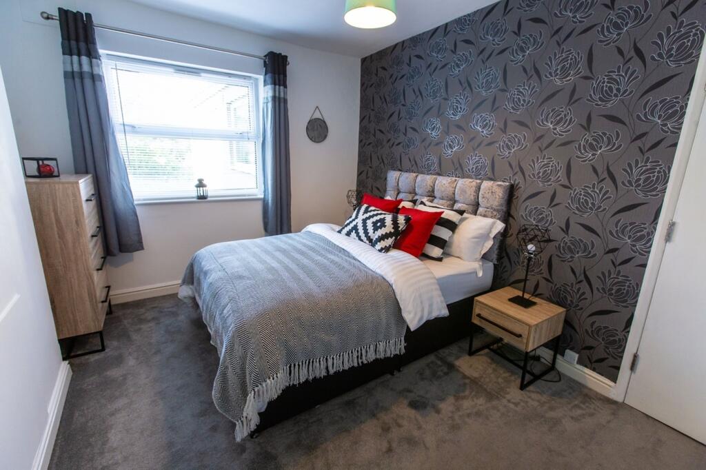 A clean and inviting double bedroom featuring s...