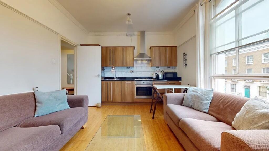 Bright and inviting living room with two comfor...