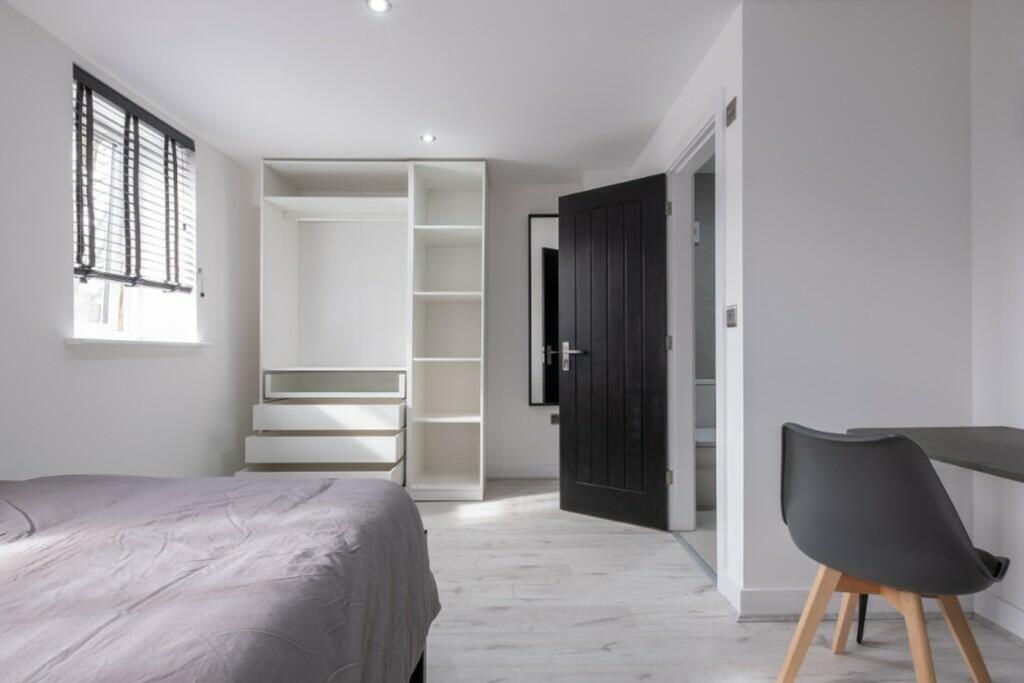 A bright and spacious double bedroom featuring ...