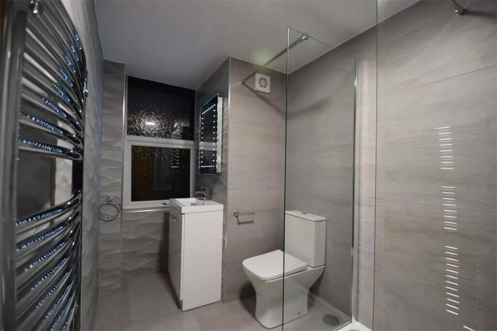 Modern bathroom featuring a sleek walk-in showe...