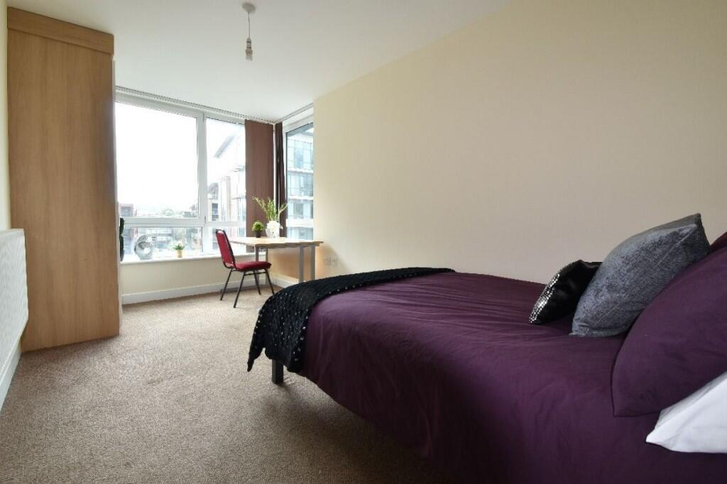 A bright and spacious master bedroom featuring ...
