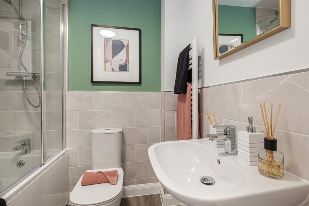 Bathroom with green painted wall above grey tiled wall