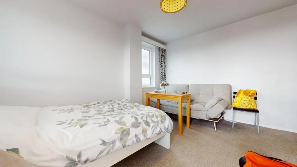 A bright and tidy double bedroom featuring a co...