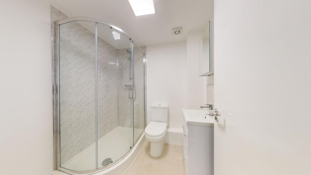 A clean and bright modern bathroom with a corne...