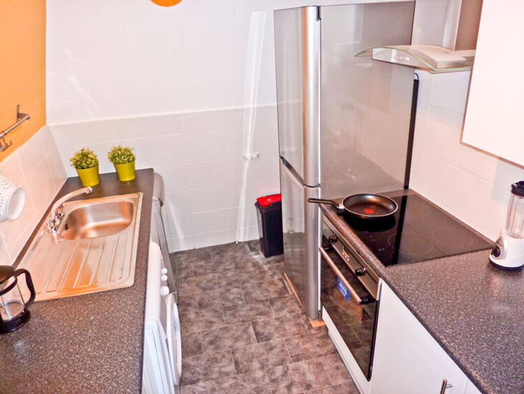 A tidy kitchen featuring modern appliances and ...