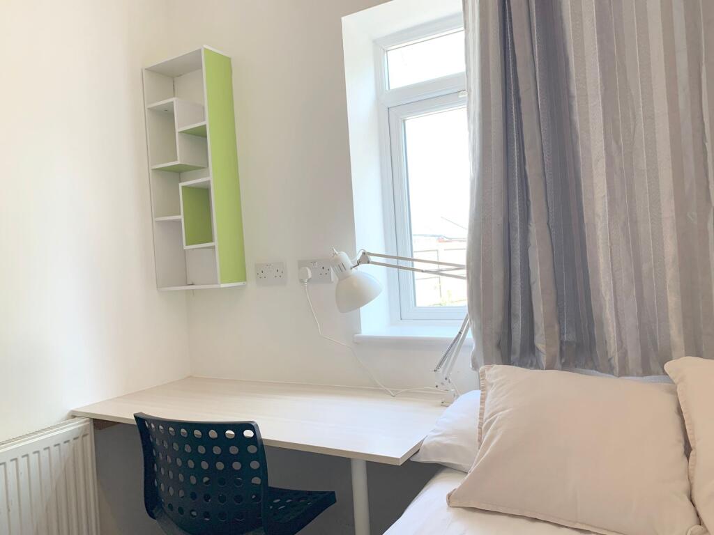 A bright and tidy single bedroom corner featuri...