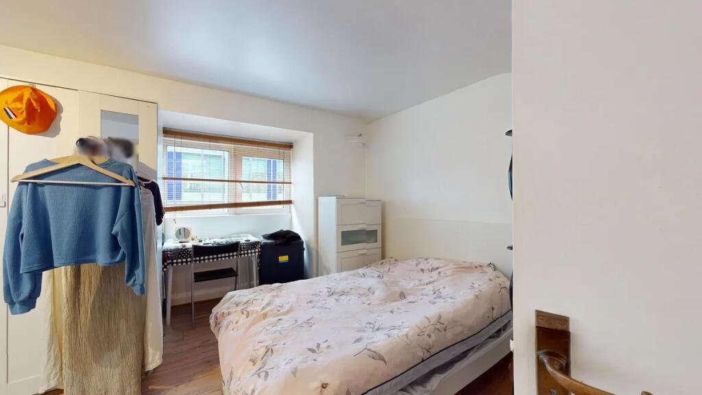 Bright and cozy double bedroom featuring a comf...