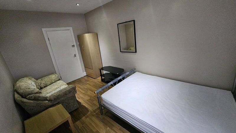 A tidy single bedroom featuring a comfortable a...