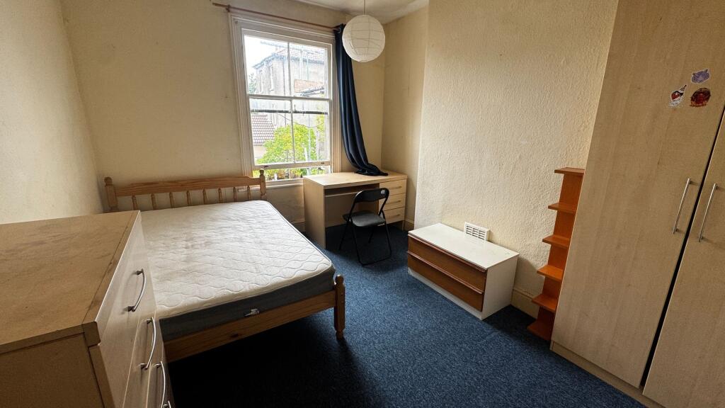 Bright and straightforward bedroom with a large...