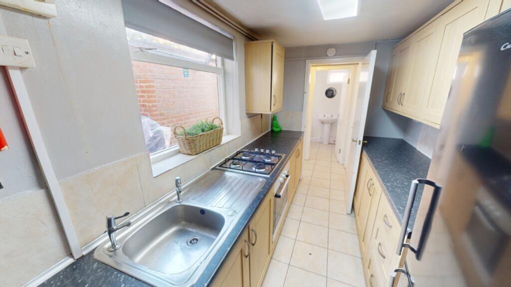 A spacious and well-lit kitchenette with modern...