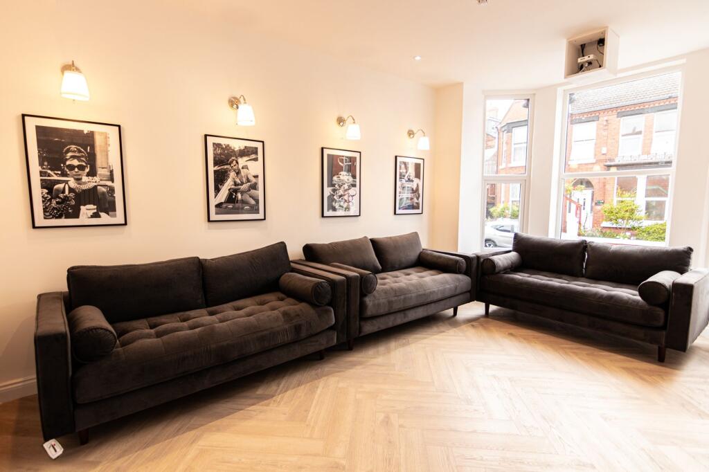 A modern, spacious living room with three comfo...