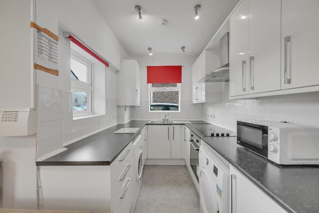 Bright and modern kitchen featuring ample count...