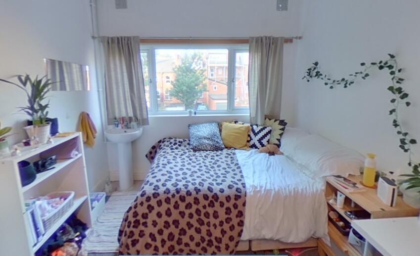 Bright and cozy master bedroom with a large win...