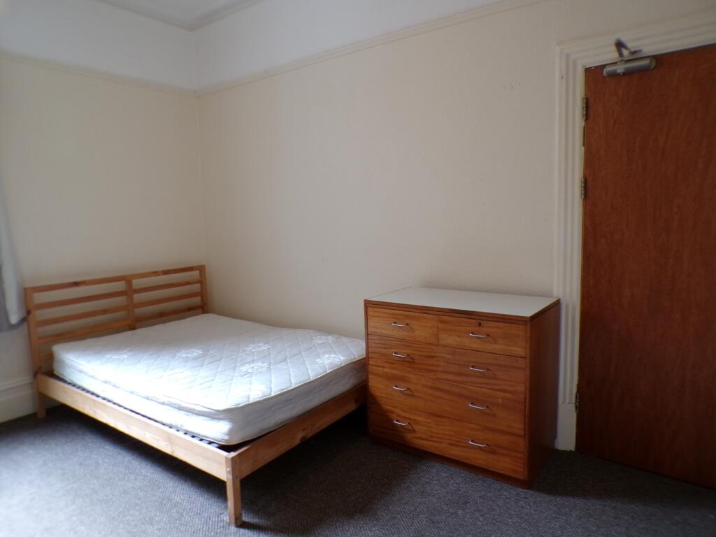 A spacious double bedroom with a clean layout, ...