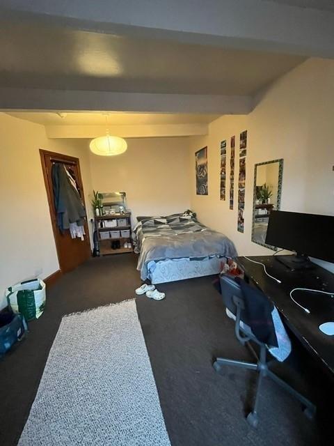 Bright, simply furnished bedroom featuring a do...