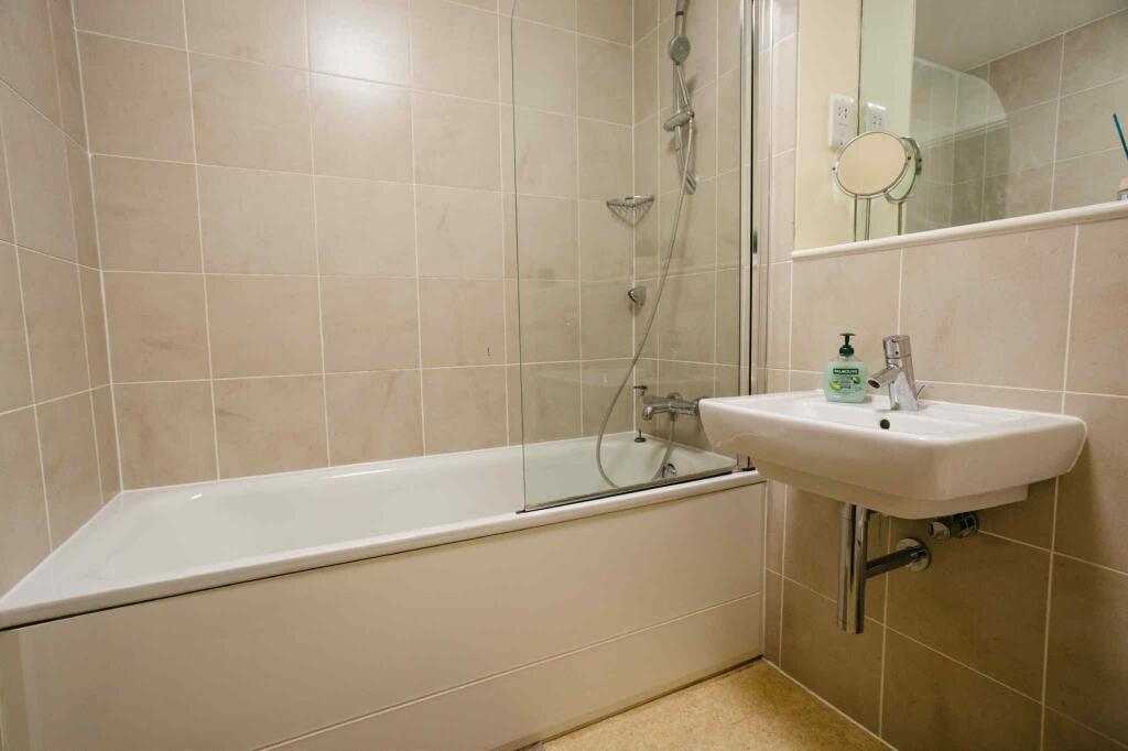 A modern bathroom suite featuring a clean white...