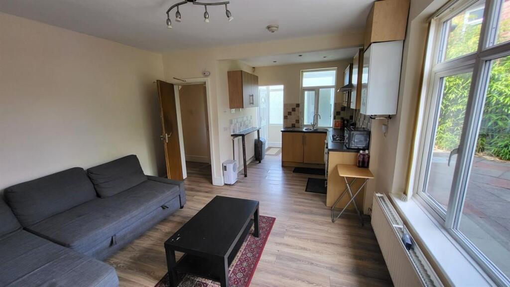 A bright and tidy living room with ample natura...