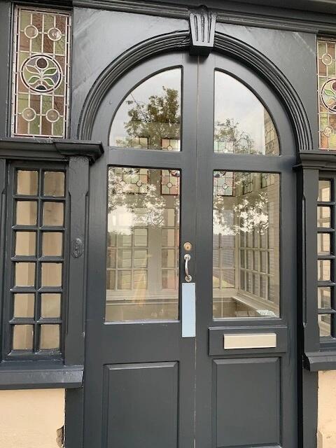 Elegant front door with decorative stained glas...