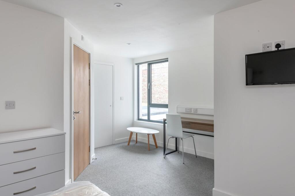 Bright and modern single bedroom featuring a la...