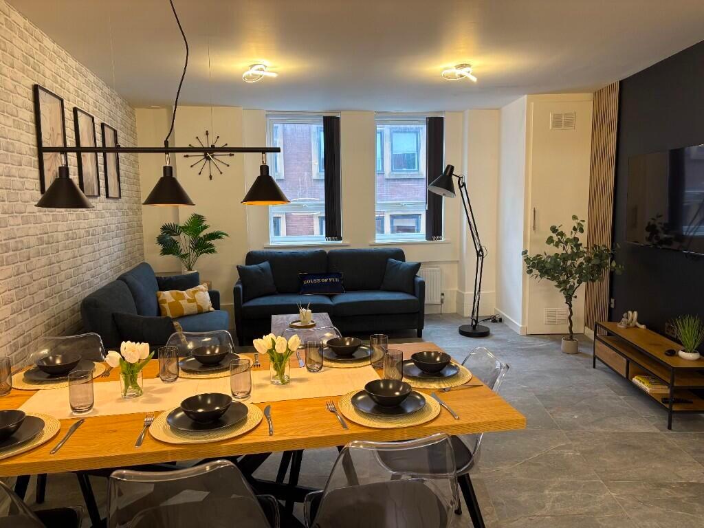 A stylish and modern living room featuring a sp...