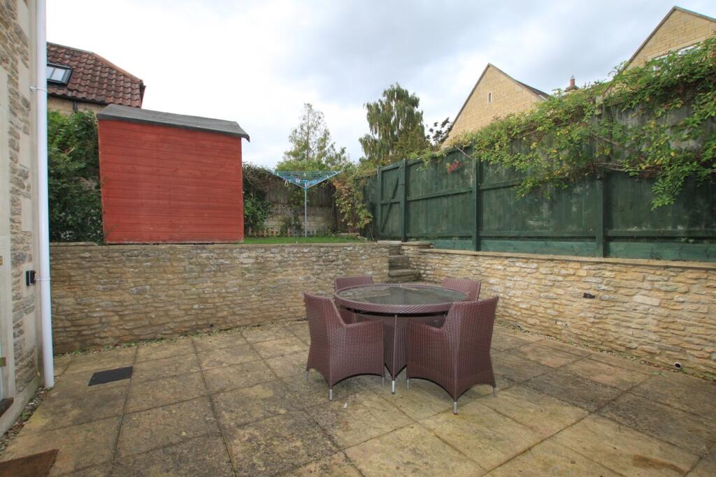 Patio area looking to raised grass area