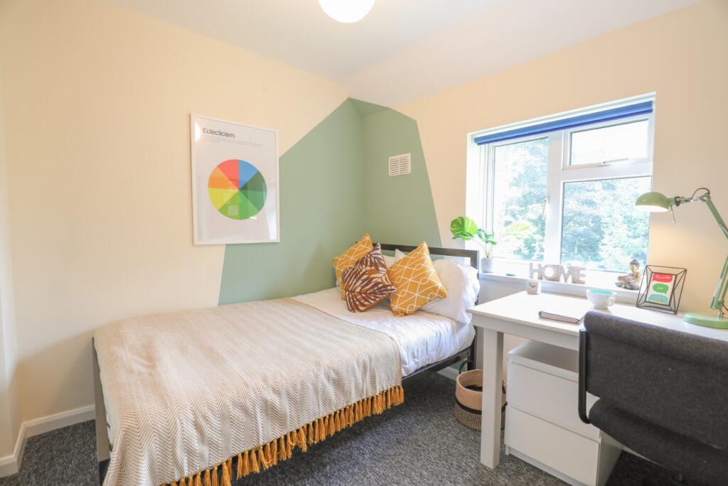 Bright and welcoming bedroom featuring a comfor...