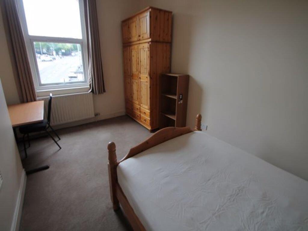 A neat and simple single bedroom featuring a be...