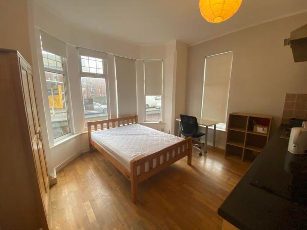 A spacious and bright double bedroom, featuring...