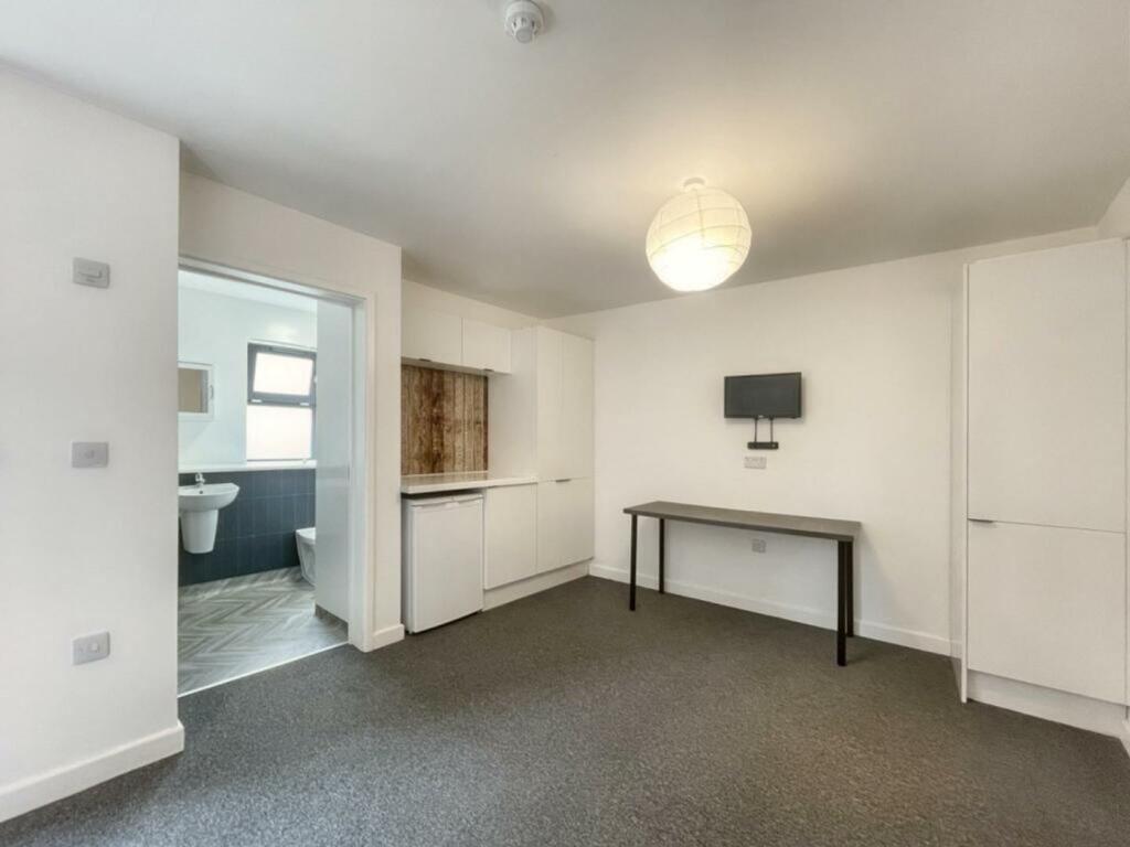 A spacious and tidy living room with modern dec...