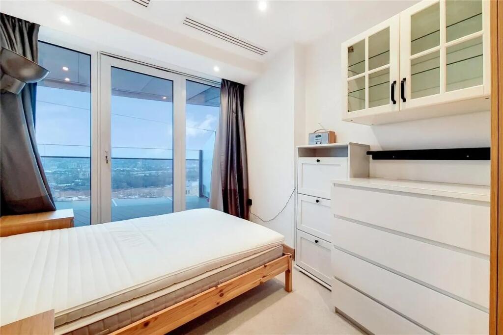 Bright and modern double bedroom featuring larg...