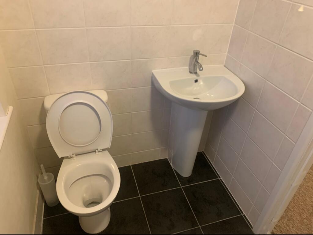 A tidy and well-maintained single toilet with m...