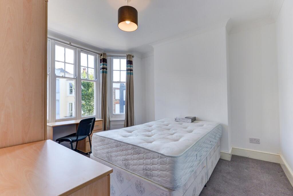 Bright and airy double bedroom featuring a larg...