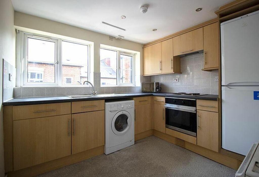 Spacious and modern kitchen featuring ample cab...