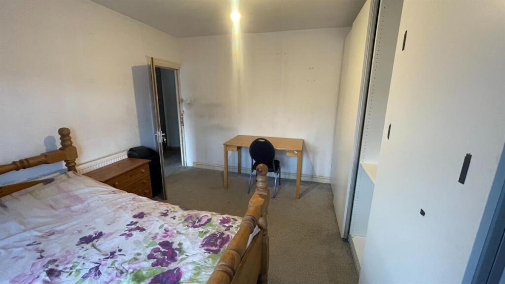 Bright, tidy bedroom with a double bed, study d...