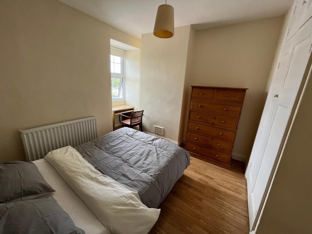 This charming double bedroom features a cozy la...