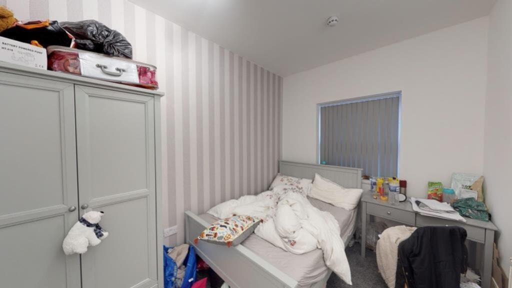 A cozy double bedroom with a comfortable bed an...